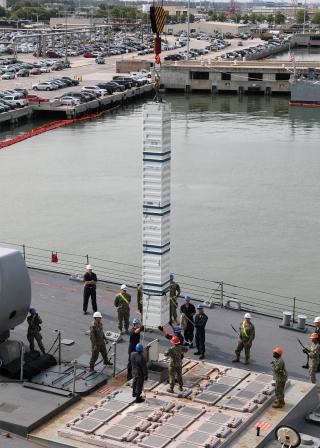 Sailors on board the Arleigh Burke-class destroyer USS Porter (DDG-78) stow simulated ordnance in the ship’s Mk 71 vertical launch system (VLS) during a pierside rearming demonstration at Naval Station Norfolk. There have been three demonstrations of the Transferable Re-Arming Mechanism (TRAM), two of which were successful.