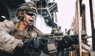 A Marine from Battalion Landing Team 1/5, 15th Marine Expeditionary Unit, during a live-fire exercise on board the amphibious assault ship USS Boxer (LHD-4). Maintenance issues have plagued amphibious ship operations. The Boxer, originally scheduled to deploy to 7th Fleet in September 2023, did not do so until late spring 2024 because of a series of equipment problems.