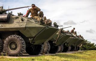 Marines from the 3d Light Armored Reconnaissance Battalion zero the M242 25-mm Bushmaster chain guns on their Light Armored Vehicle 25s at Camp Schwab, Okinawa, Japan, in August.  General Dynamics and Textron are competing to design and deliver a new vehicle equipped with 30-mm cannon that the Marine Corps hopes to begin procuring by fiscal year 2028.