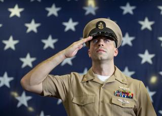 Chief Aviation Electrician’s Mate Collin Peskett, assigned to amphibious assault ship USS Boxer (LHD 4), passes through the sideboys during the chief petty officer pinning ceremony in the hangar bay. 