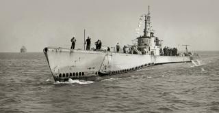 Photographed late in the war, the Sealion is festooned with Japanese ship-kill flags flying from her mast.