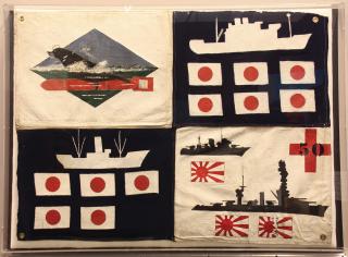 The sinking of the Kongo– is depicted in the lower right quadrant of the Sealion battle flag, made by members of the submarine’s crew and presented to their commander. The Kongo– is the large battleship depicted above the broken rising-sun flag.