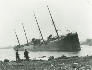 The Norwegian ship Imo beached on the Dartmouth shore after the explosion. The Imo and the Mont-Blanc collided in a hard-to-maneuver stretch of Halifax Harbor, igniting a fire on board the Mont-Blanc that would lead to her explosion.  