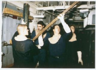 Sailors shore up a damaged bulkhead