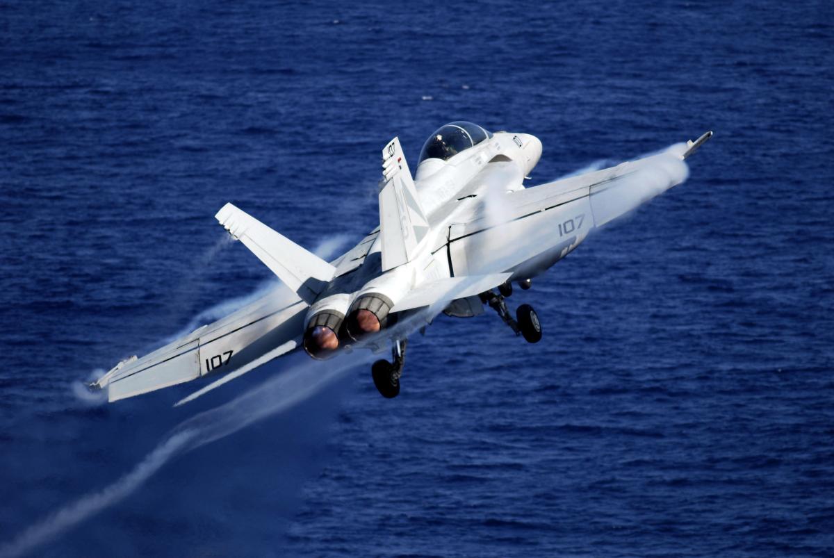 An F/A-18F Super Hornet from the "Black Knights" of Strike Fighter Squadron (VFA) 154 launches from the Nimitz-class aircraft carrier USS John C. Stennis (CVN-74)