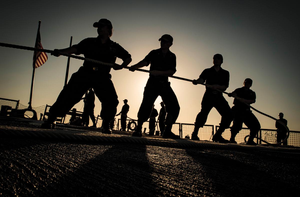 Sailors heave mooring line aboard the Arleigh Burke-class guided-missile destroyer USS Carney (DDG 64) as the ship arrives in Valencia, Spain, Sept. 21, 2018