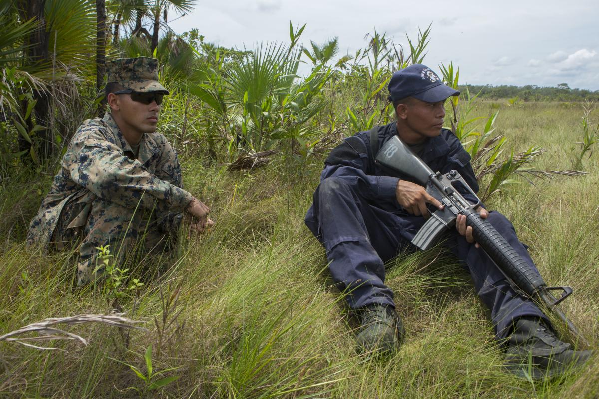 U.S. Marine Corps Cpl. Jorge Flores advises Seaman Apprentice, Belize Coast Guard, Nue Hernandez.