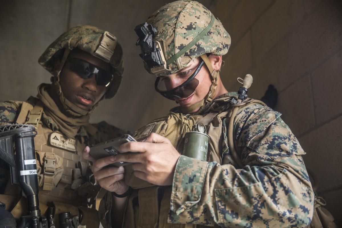 Marines look at mobile phone