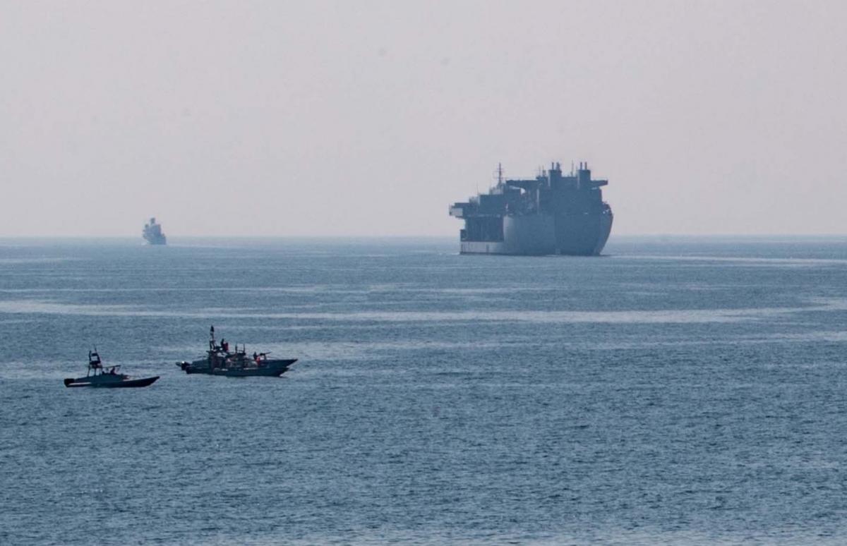 Iranian small boats frequently harrass U.S. Navy ships in the Arabian Gulf, most recently in a widely publicized series of incidents in April 2020. Here, several Iranian boats observe the USS Lewis B. Puller (ESB-3) during her passage through the Strait of Hormuz.