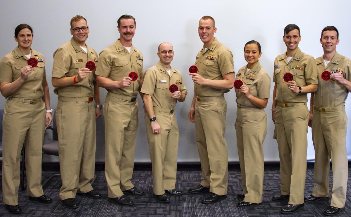 Weapons tactics instructor graduates pose with their patches.