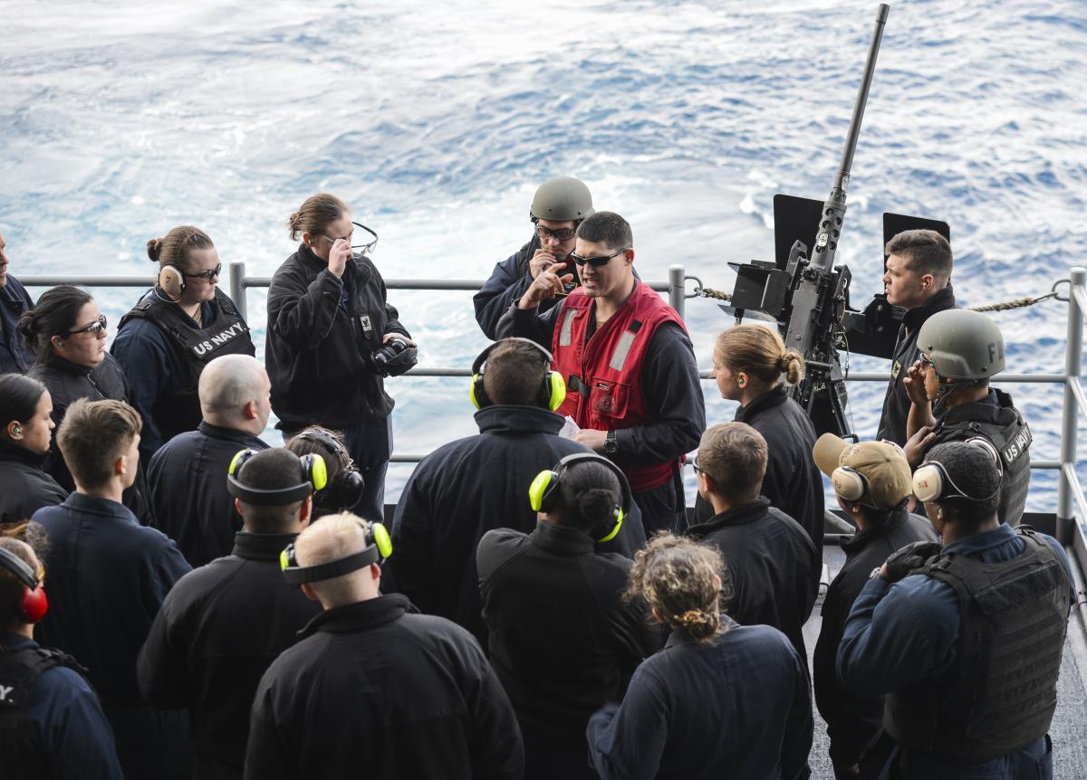 Sailors listen to a safety brief on board the USS Nimitz.