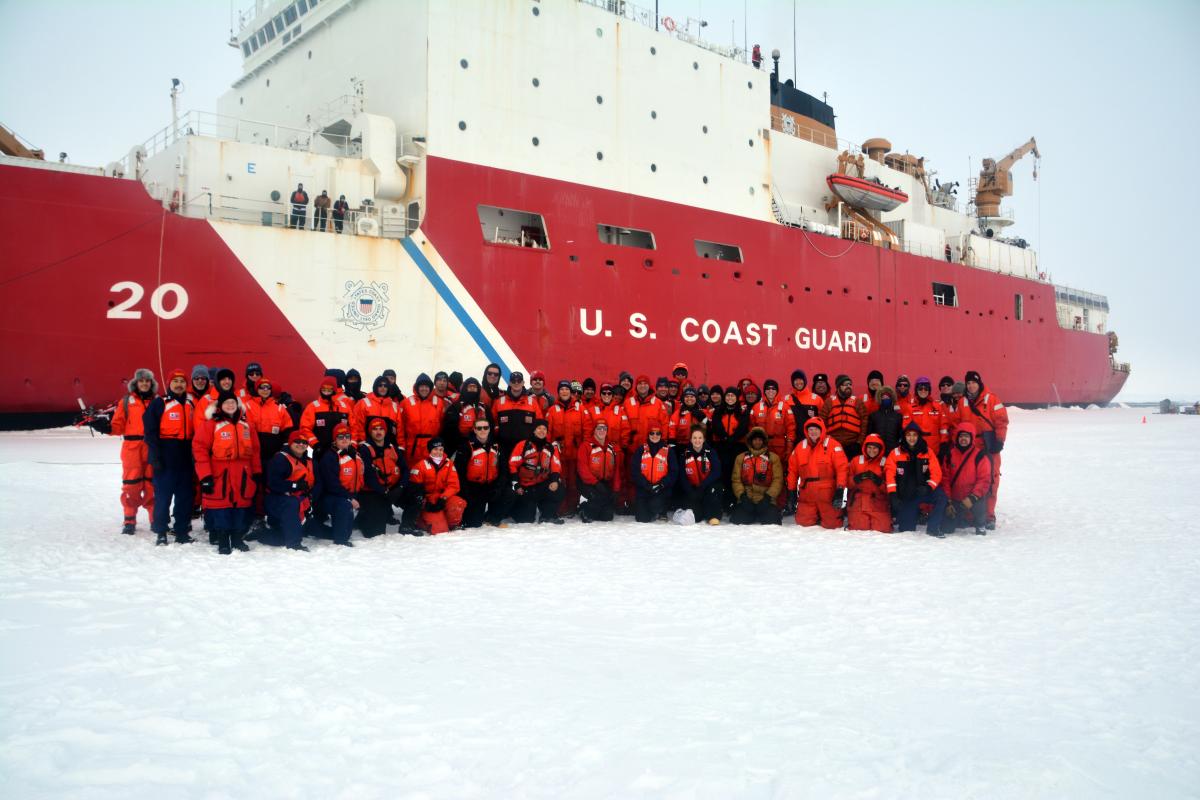Coast Guard Cutter Healy (WAGB-20) crewmembers and scientists pose for a group photo during Healy’s first ice station while deployed to the Arctic Ocean in 2019.