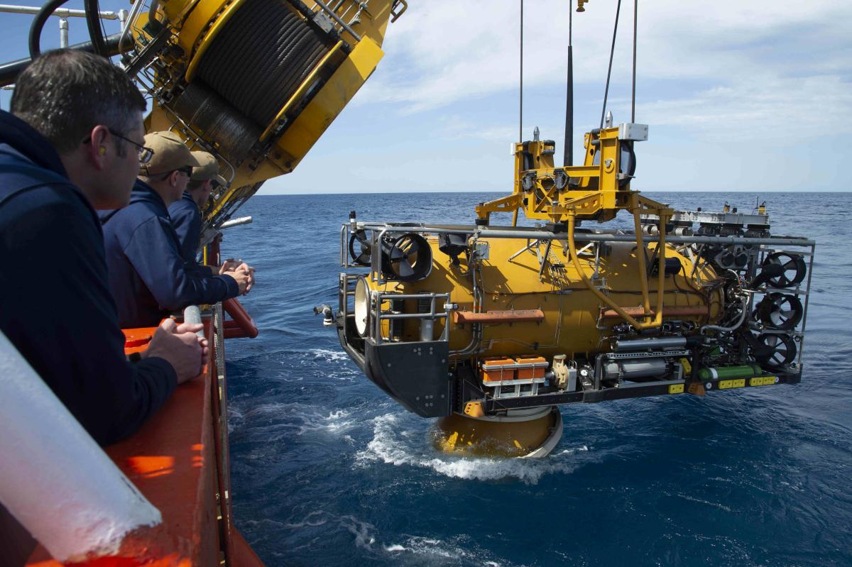 Sailors assigned to the Navy’s Undersea Rescue Command observe as the U.S. Navy Pressurized Rescue Module (PRM) system deploys from the Royal Malaysian Submarine Rescue Ship, MV Mega Bakti, during Exercise Pacific Reach (PACREACH) in 2019. 