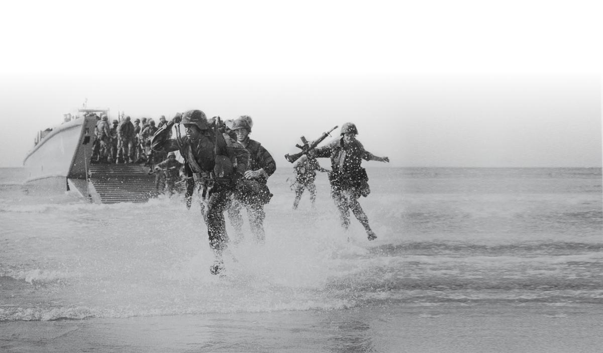 4th Marine Expeditionary Brigade (4th MEB) disembark from an LCM-6 boat while conducting amphibious assaults on Onslow Beach