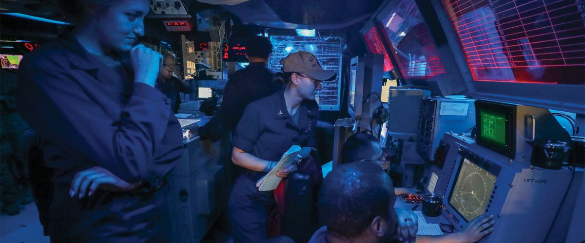Sailors in the combat information center of the Arleigh Burke–class guided-missile destroyer USS Higgins (DDG-76) operating in the Philippine Sea.  