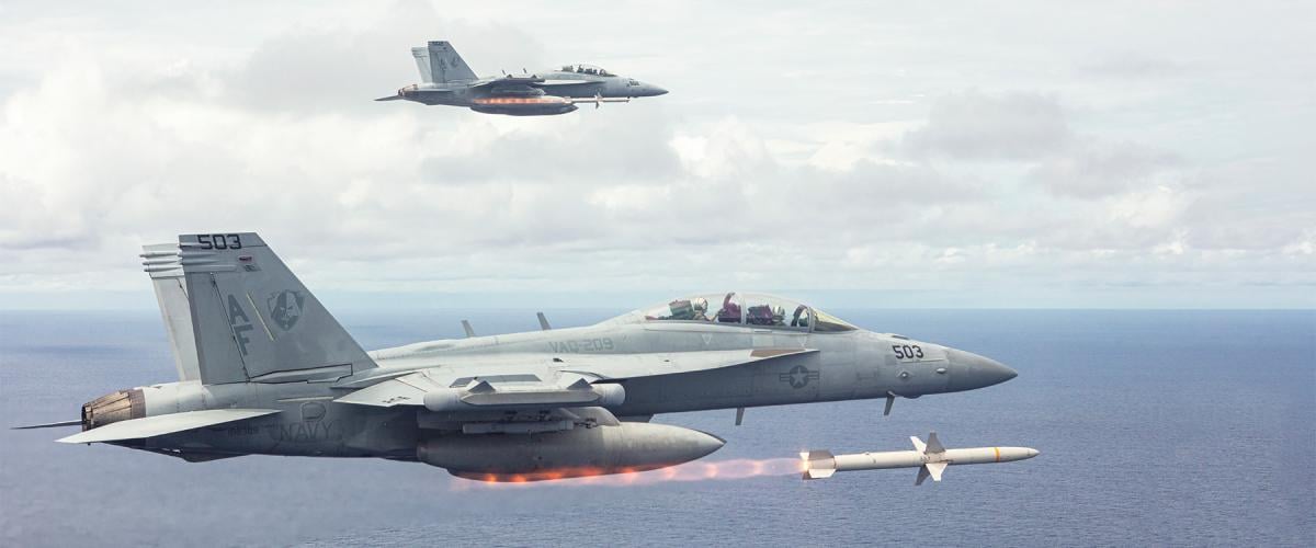 EA-18G Growlers from Electronic Attack Squadron (VAQ) 209 simultaneously fire two AGM-88  high-speed antiradiation missiles during a training exercise near Guam. The AGM-88 is the Navy’s sole antiradiation strike missile, and relatively short ranged considering the threat in the 2026 scenario.
