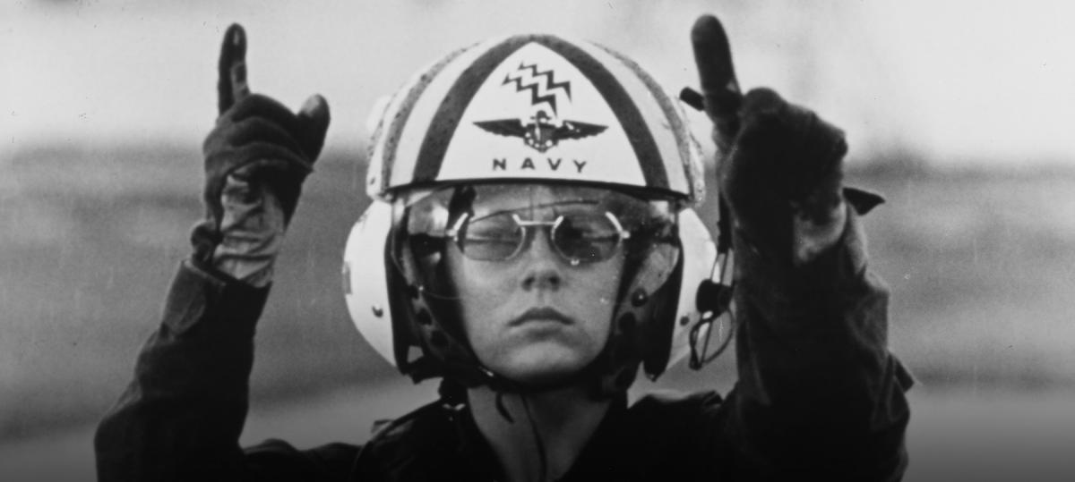 Dianna Heath signals the pilot of a UH-1N Iroquois helicopter