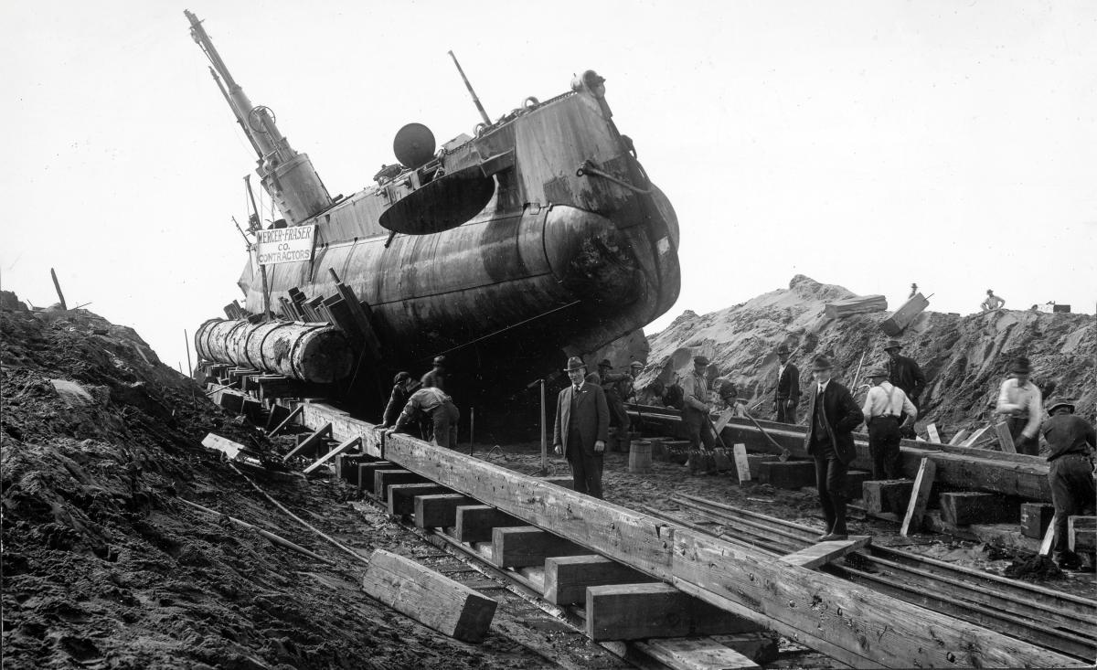 Starboard bow view of submarine USS H-3 on a wooden cradle after being beached.