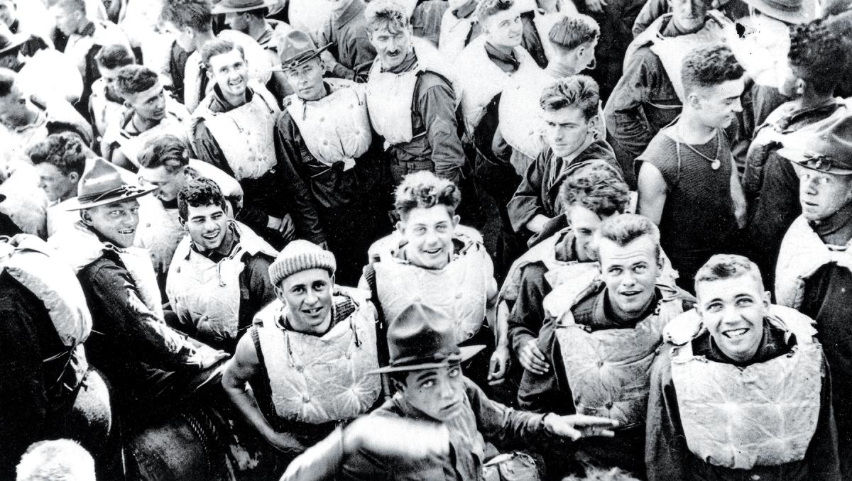 Troops in life jackets crowd the main deck of the USS President Lincoln as she steams through the submarine “danger zone” in the Atlantic on 25 December 1917.