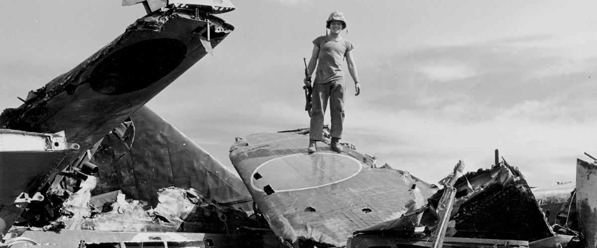 Symbolizing the Marine Corps’ victory in the Battle of Saipan,  a rifleman stands atop the wreckage of Japanese planes destroyed in the fight for the Mariana Islands base.
