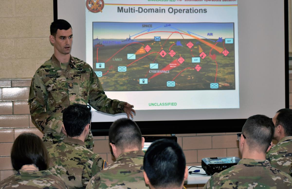 An Army IO officer briefs soldiers