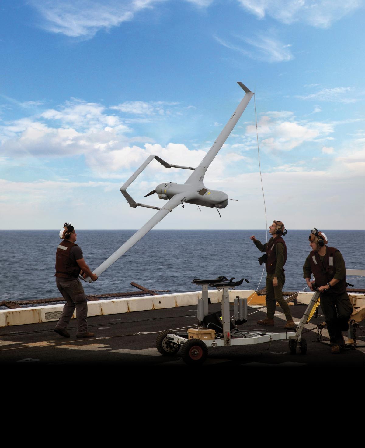 Marines with Marine Medium Tiltrotor Squadron 365 Reinforced lower an RQ-21A Blackjack unmanned aerial surveillance aircraft down from the STUAS recovery system using the vertical capture rope as the 24th Marine Expeditionary Unit and USS Mesa Verde (LPD-19).