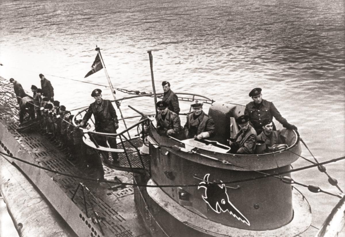 Several people on a U-boat in black and white. 