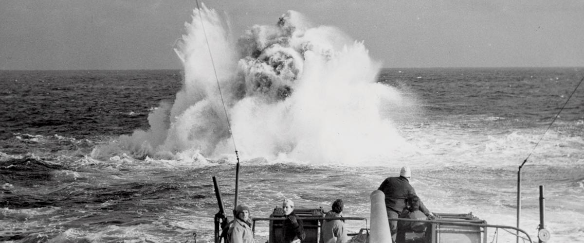 A Coast Guard combat cutter patrolling the North Atlantic looses a depth charge in battle practice sometime during World War II.