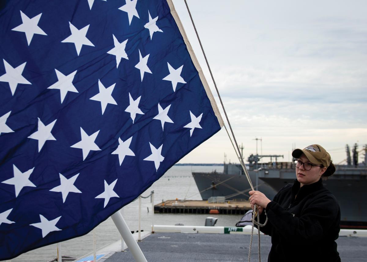 C&D-PRO-4-19 1  Quartermaster 2nd Class Taylor Miller, from Kent, Ohio, unfurls the union jack on the jack staff of the aircraft carrier USS Dwight D. Eisenhower (CVN-69) on February 19, 2019.