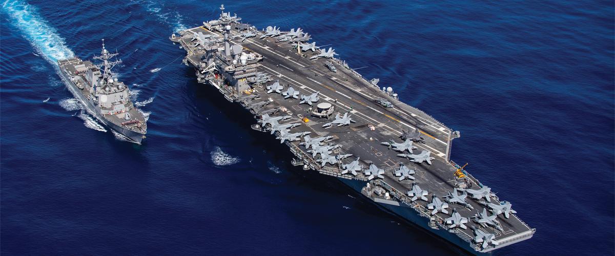 The aircraft carrier USS Carl Vinson (CVN-70), right, and the guided-missile destroyer  USS Dewey (DDG-105) prepare to transfer fuel during a replenishment-at-sea.