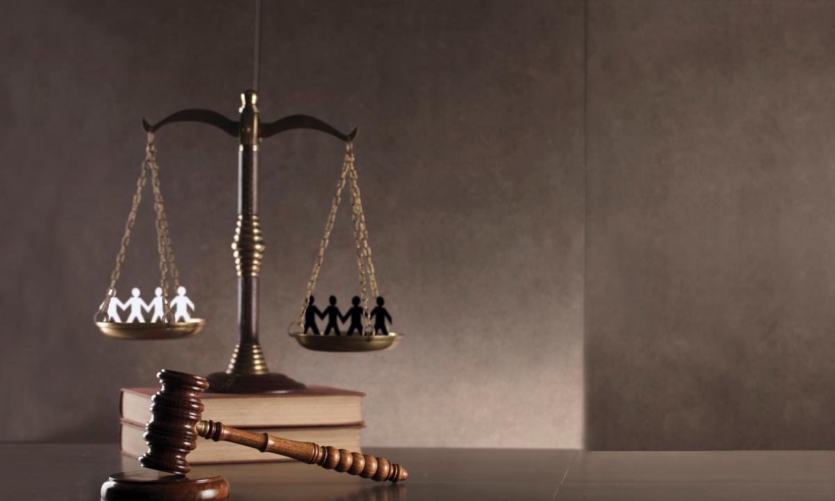 Scales resting on books with gavel
