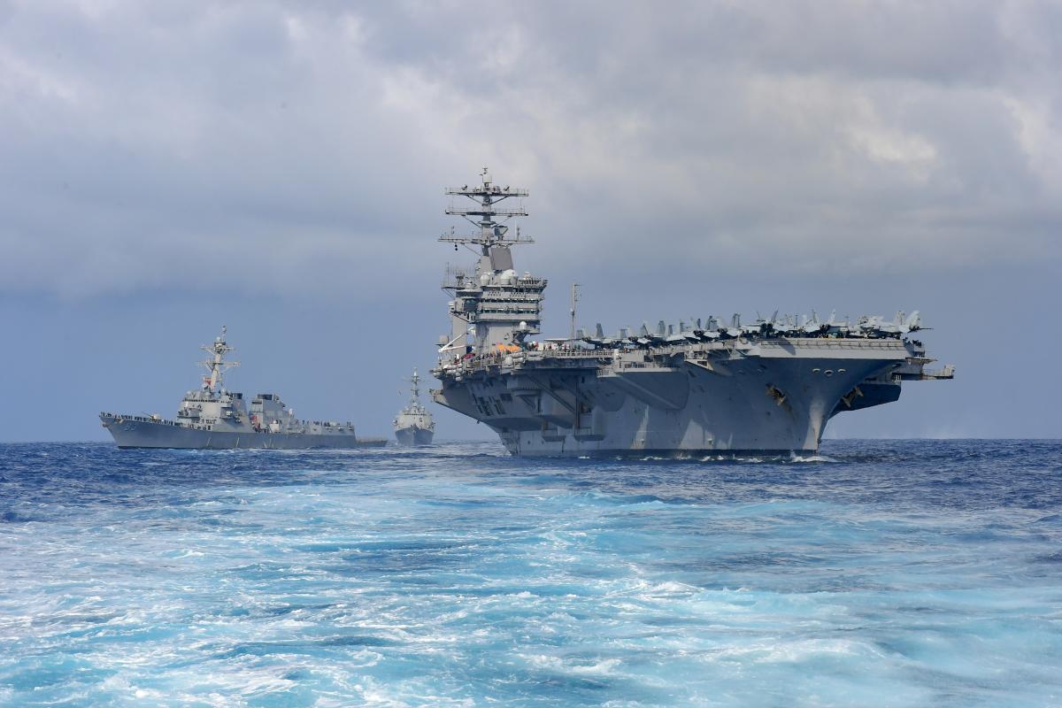 The aircraft carrier USS Nimitz (CVN 68) steams ahead of the Arleigh Burke-class guided missile destroyers USS Howard (DDG 83) and USS Shoup (DDG 86) during a demonstration