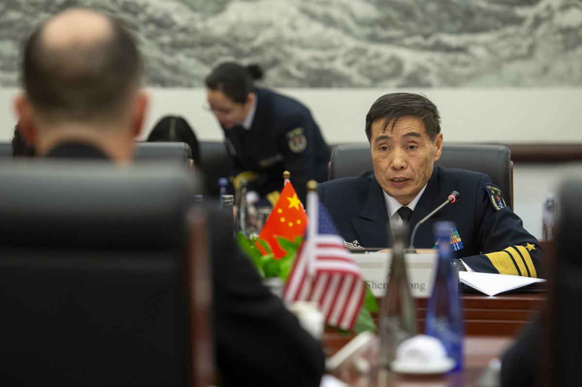 Chinese Navy Admiral Shen Jilong sitting at a table