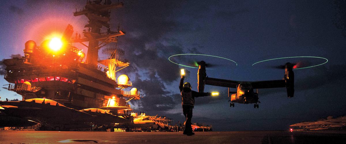 A U.S. Air Force CV-22B Osprey with the 352nd Special Operations Wing prepares to take off from the flight deck of a U.S. Navy Nimitz-class aircraft carrier.