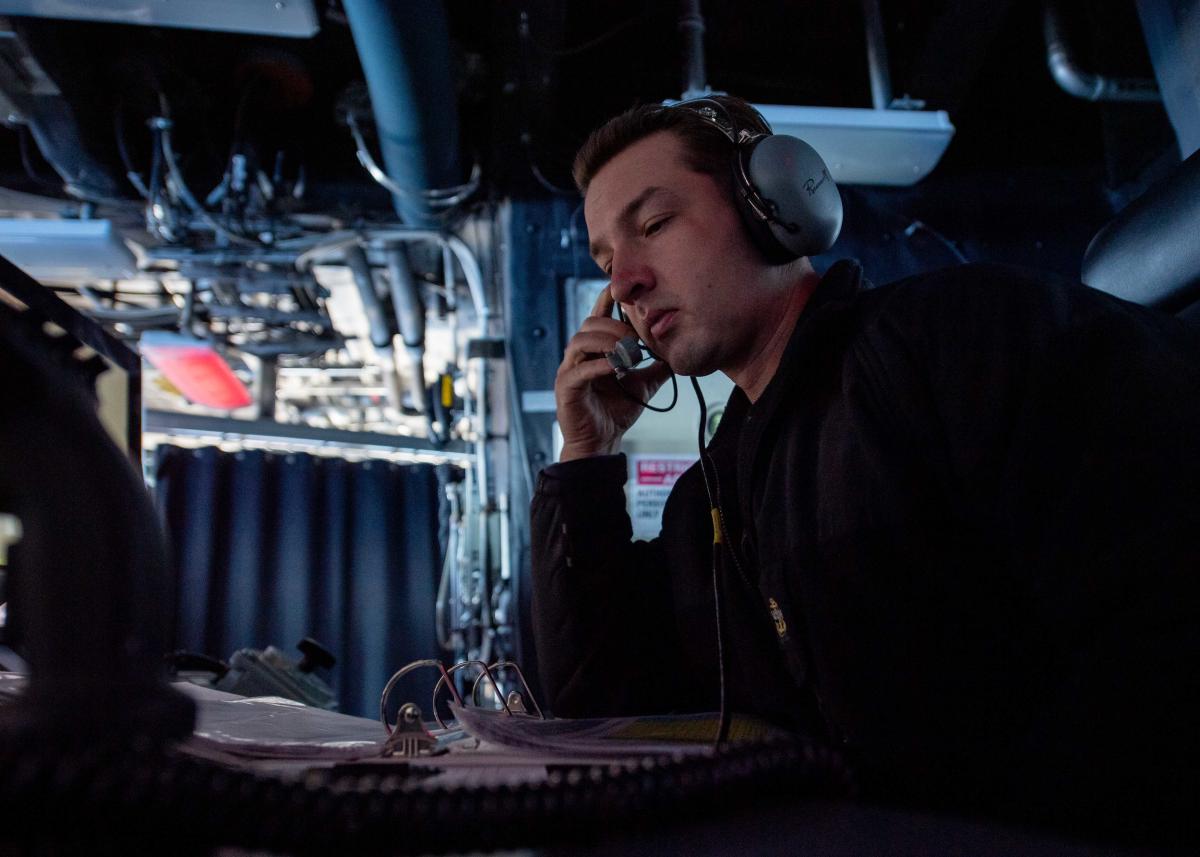 chief operations specialist stands watch