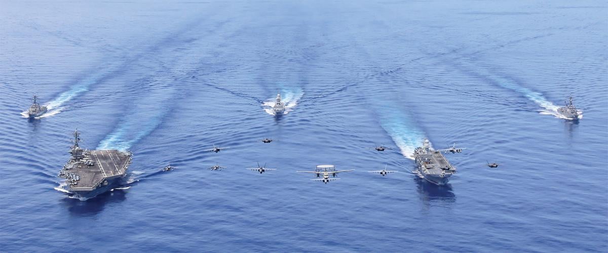 The Abraham Lincoln Carrier Strike Group (CSG) and the Italian Navy’s Cavour CSG sail in formation in the U.S. Seventh Fleet area of operations. The Navy’s reduced fleet now bears the weight of constant forward-presence missions, which are taxing the service’s operational resilience. 