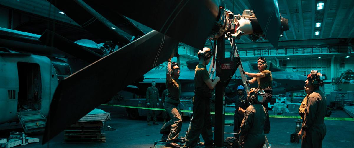 U.S. Marines and sailors conduct maintenance on the rotor assembly of an MV-22B Osprey. The Naval Air Training and Operating Procedures Standardization (NATOPS) requirements for rest must be followed for all personnel, not just the flight crew.