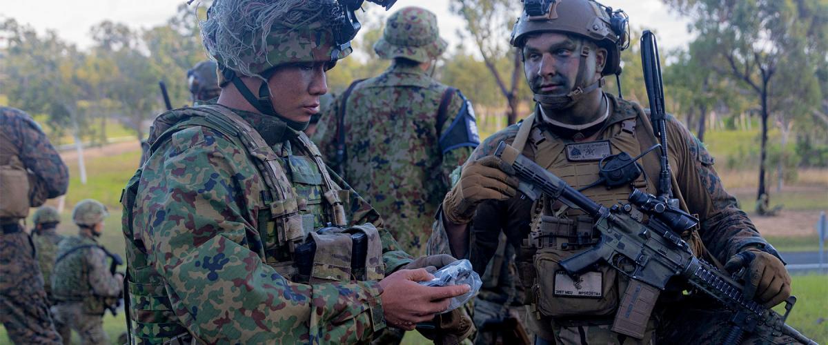 Marines of Battalion Landing Team 2/1, 31st Marine Expeditionary Unit, inspect gear with the Amphibious Rapid Deployment Regiment, Japan Ground Self-Defense Force, at Midge Point, Australia, during Exercise Talisman Sabre 23. Expanded education on adversary culture and doctrine would better prepare NCOs to adapt to complicated environments.
