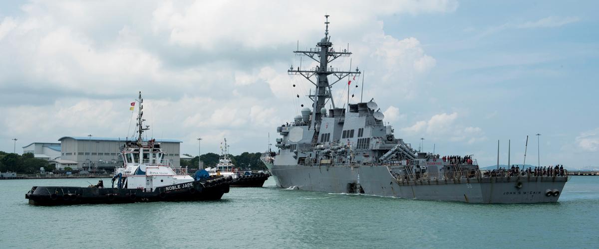 Tugboats assist the USS John S. McCain (DDG-56) 