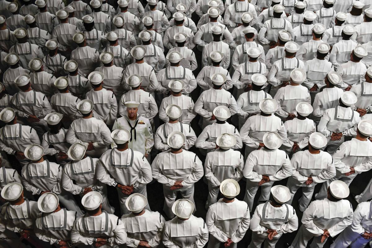 U.S. Sailors stand at parade rest during a Change of Command ceremony aboard the amphibious assault ship USS Wasp (LHD 1) in Subic Bay