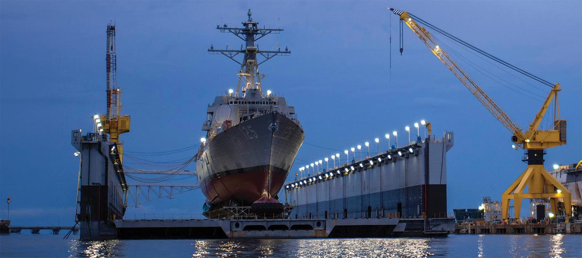 The guided-missile destroyer USS Jack H. Lucas (DDG-125) seen in June 2021 preparing for her commissioning in Pascagoula, Mississippi. In 2002, the HII Pascagoula yard was owned by Northrop Grumman Ship Systems, which grudgingly agreed to a Navy proposal to send some DDG construction to Bath Iron Works in Maine in return for taking on construction of the full San Antonio–class amphibious transport dock line instead of sharing production with Bath.