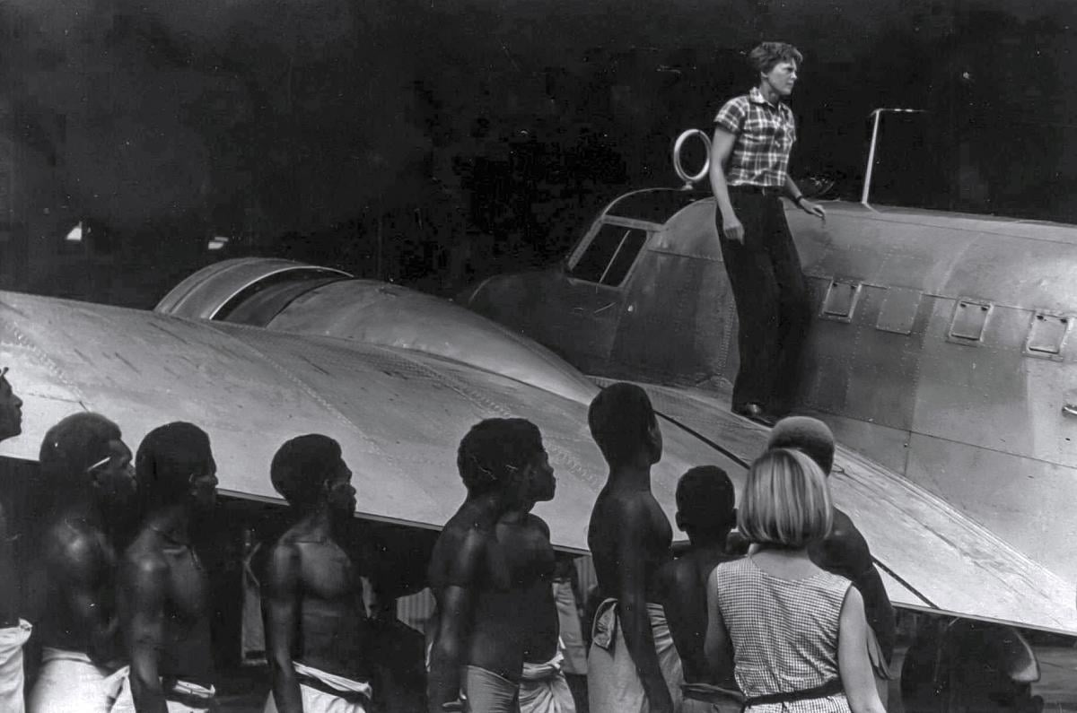 Amelia Earhart dismounting her Lockheed Electra on Lea