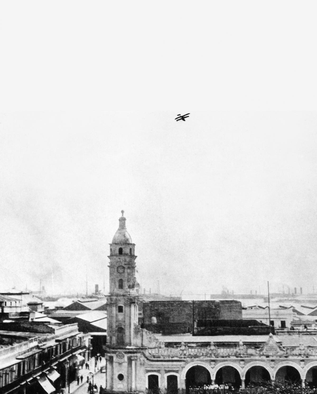The Curtiss flying boat AB-3 soars over Vera Cruz as its pilot and observer search for enemy snipers on city rooftops during the U.S. intervention in the Mexican Revolution. 