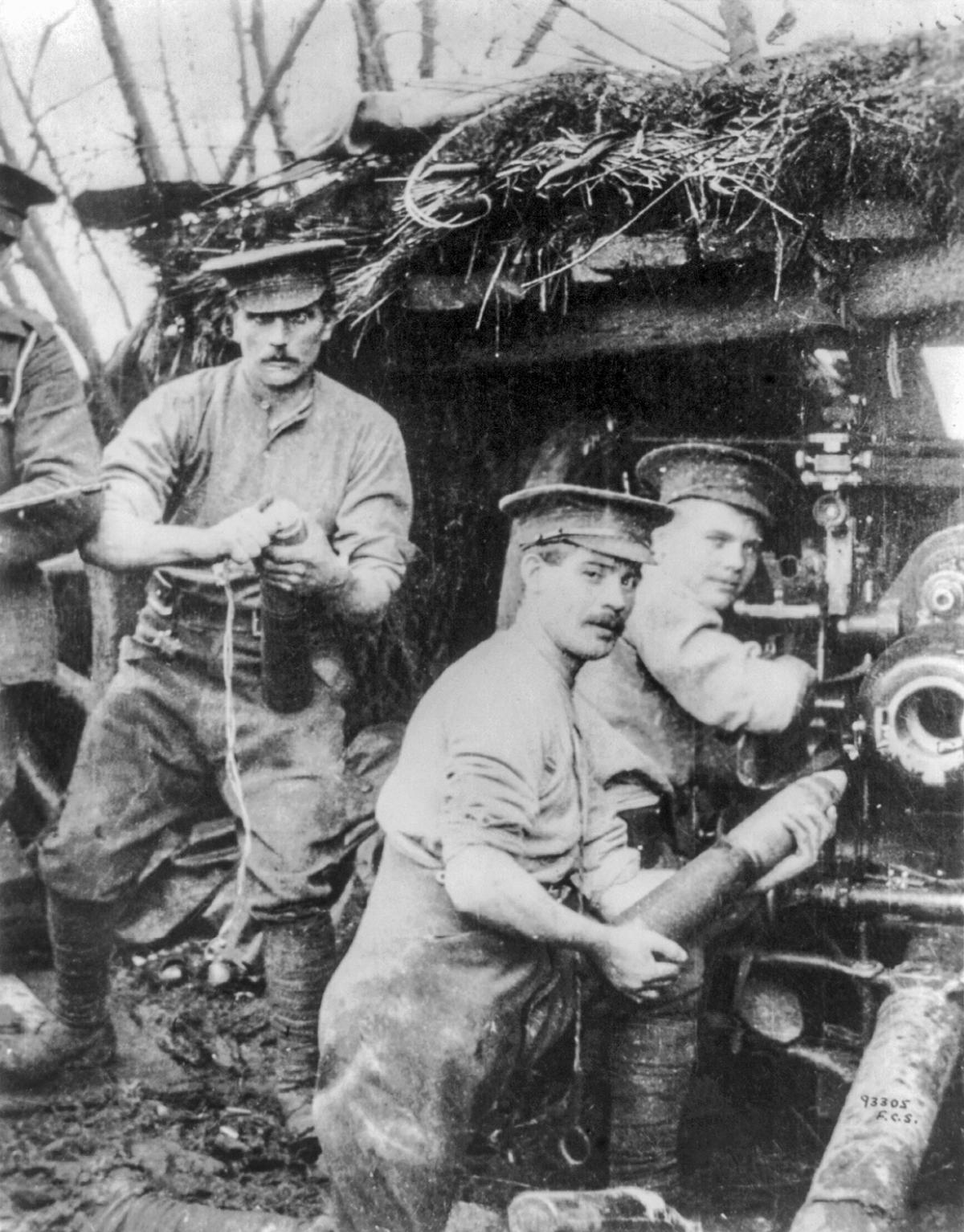 British troops load their gun in a camouflaged bunker circa April 1915