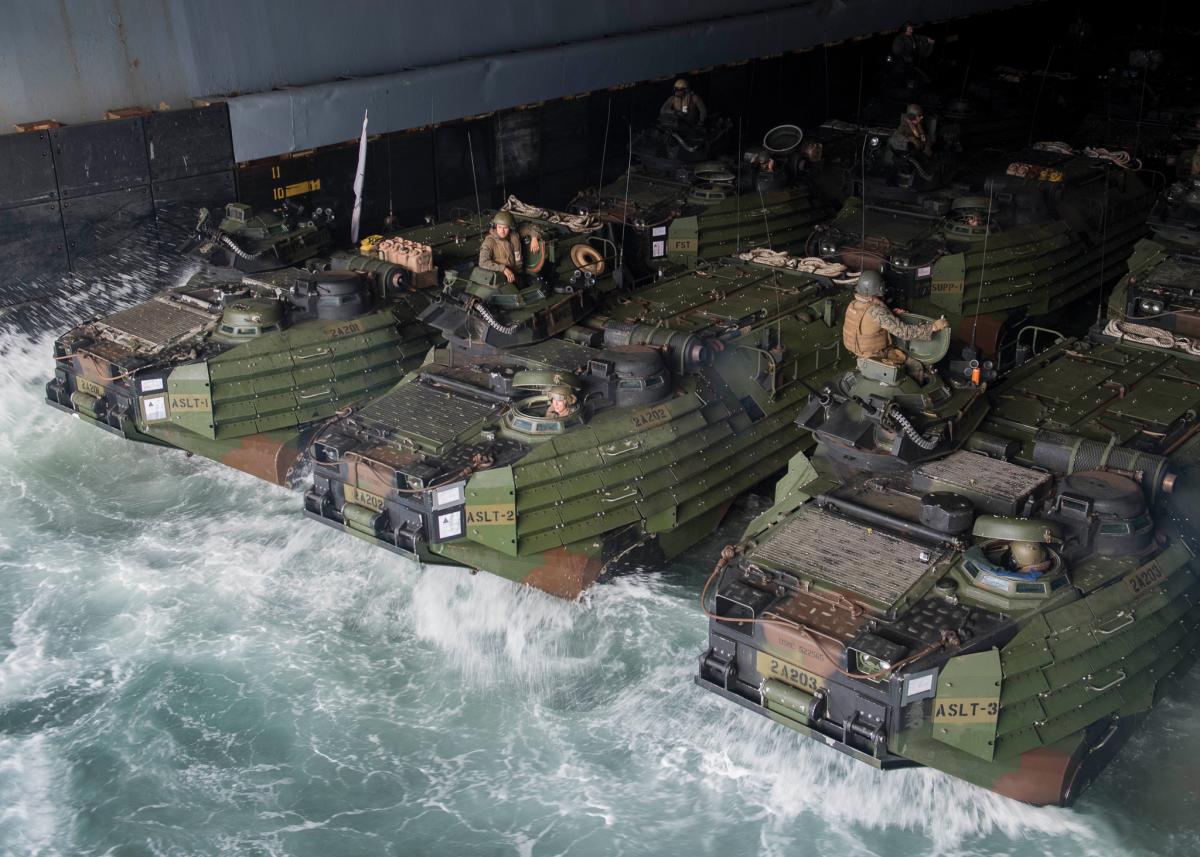 Marines and Sailors, assigned to the 26th Marine Expeditionary Unit, stage AAV P7/A1 assault amphibious vehicles in the well deck of the Harpers Ferry-class dock landing ship USS Oak Hill (LSD-51)