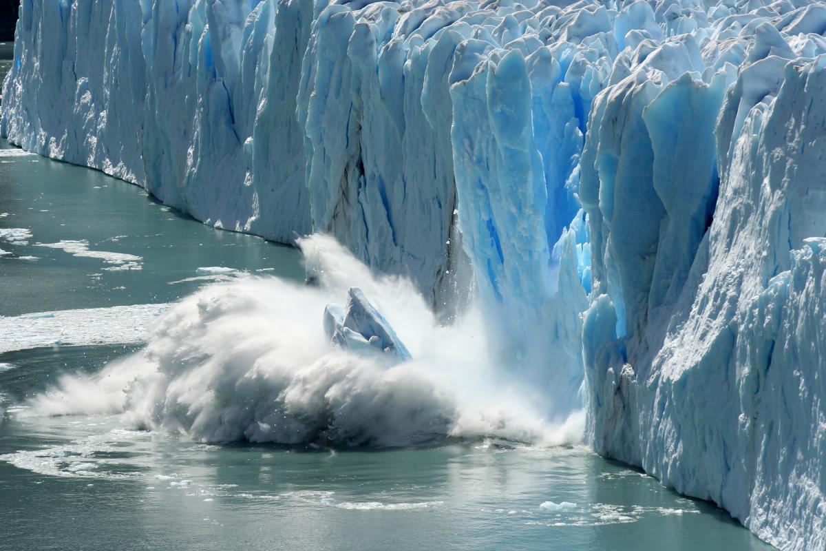 Iceberg falling into the ocean