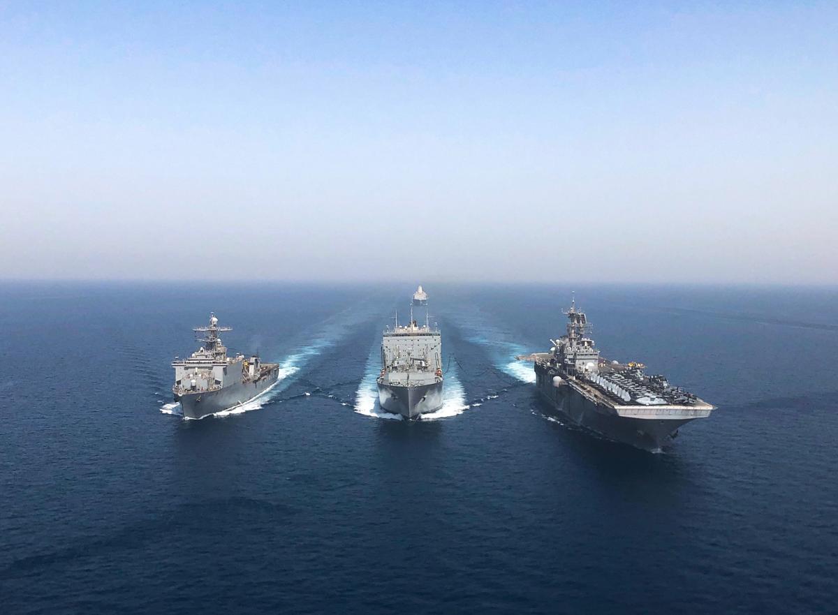  The amphibious dock landing ship USS Oak Hill (LSD-51), left, the dry cargo and ammunition ship USS Robert E. Peary (T-AKE-5), and amphibious assault ship ISS Bataan (LHD-5) execute a replenishment at sea in the Arabian Gulf this past April.
