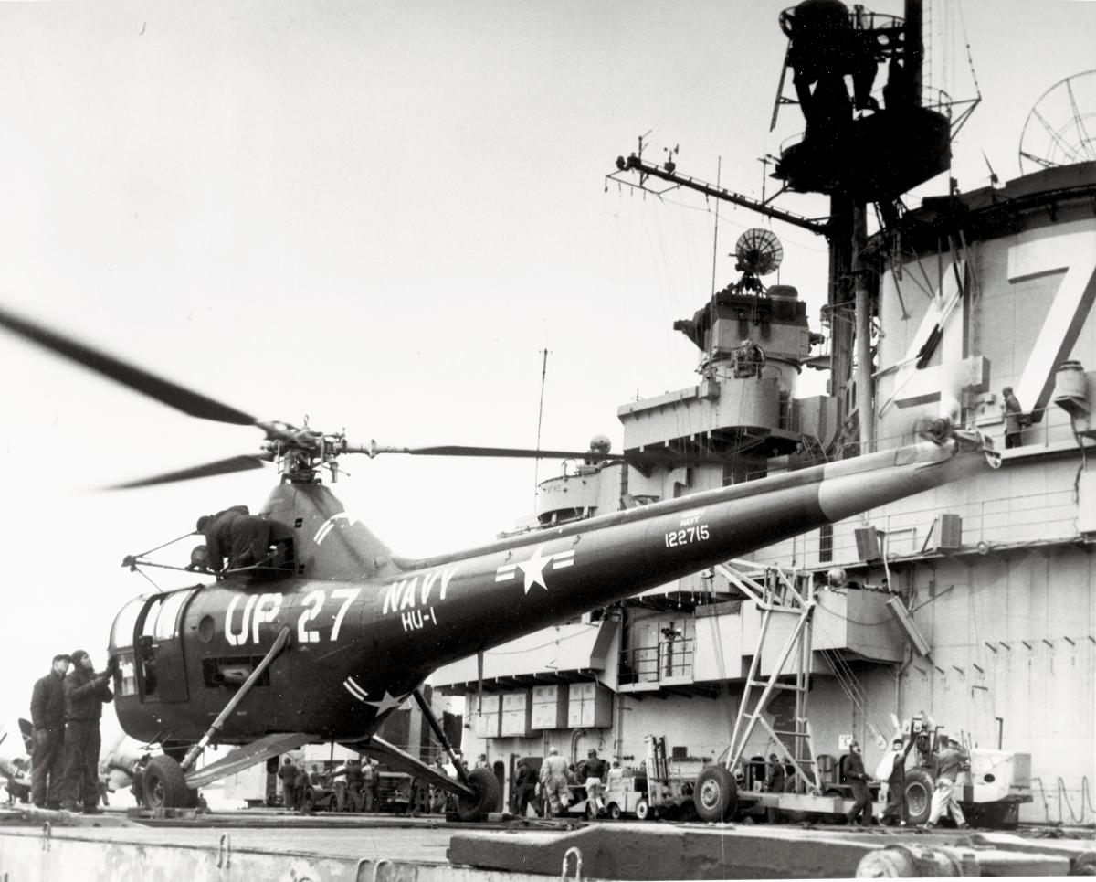 A Sikorsky HO3S-1 helicopter rests on the carrier USS Philippine Sea (CV-47) during the Korean War. These helicopters were flown in large numbers during the conflict for VIP and mail delivery, search and rescue, gunfire spotting—and mine-spotting.