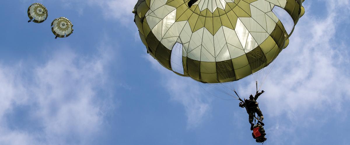 Japan Ground Self-Defense Force soldiers from the 1st Airborne Brigade descend from a U.S. Air Force C-130J Super Hercules over Narashino Training Area, Japan, in April 2022.