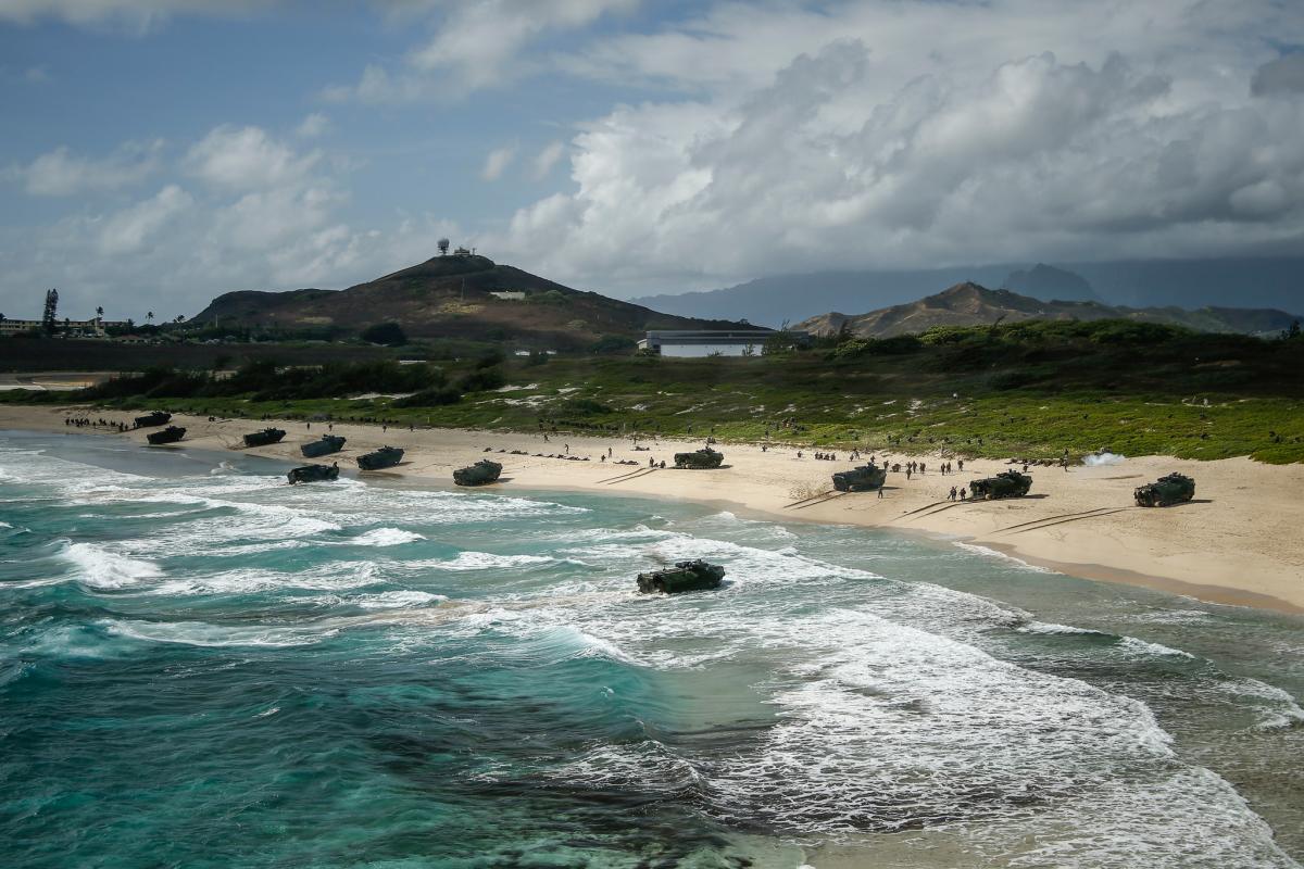 AAV-P7/A1 assault amphibious vehicles assigned to Combat Assault Company, 3rd Marine Regiment, unload service members during an amphibious landing demonstration as part of Rim of the Pacific (RIMPAC) exercise at Pyramid Rock Beach on Marine Corps Base Hawaii July 29, 2018